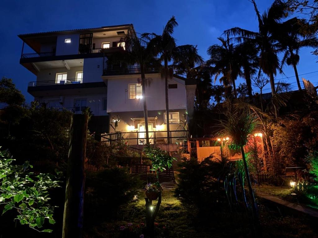 a house with lights in front of it at night at Villa Alta Vista in São Jorge