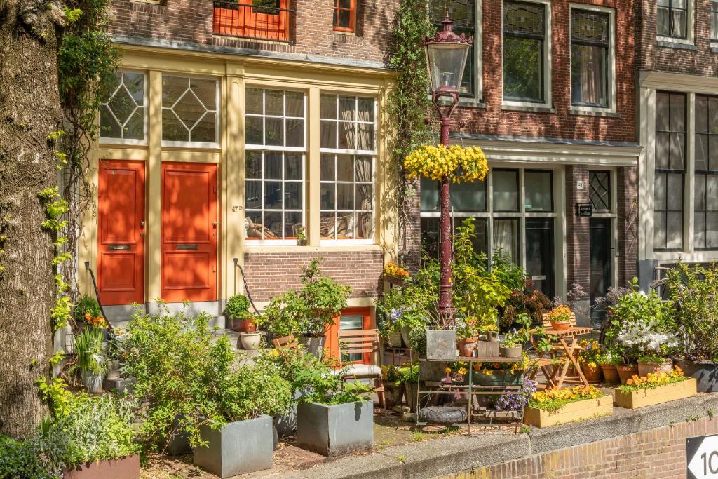 a house with a lot of plants in front of it at The Orange Canals Suite in Amsterdam