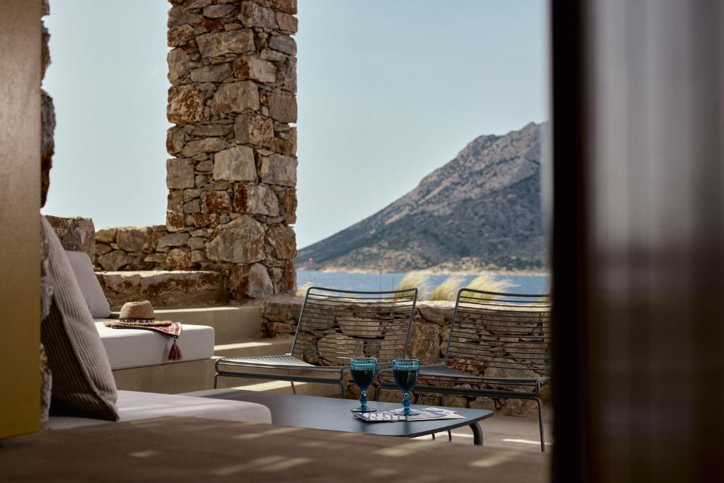 a room with two wine glasses on a table at Amorgina in Amorgos