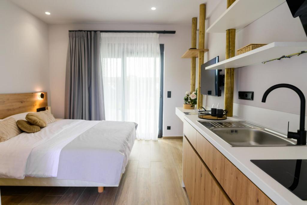 a bedroom with a large bed and a sink at Aura Otto Luxury Living in Alexandroupoli
