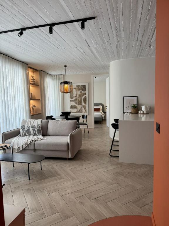 a living room with a couch and a table at Stylish Designer Apartment in Mellieħa