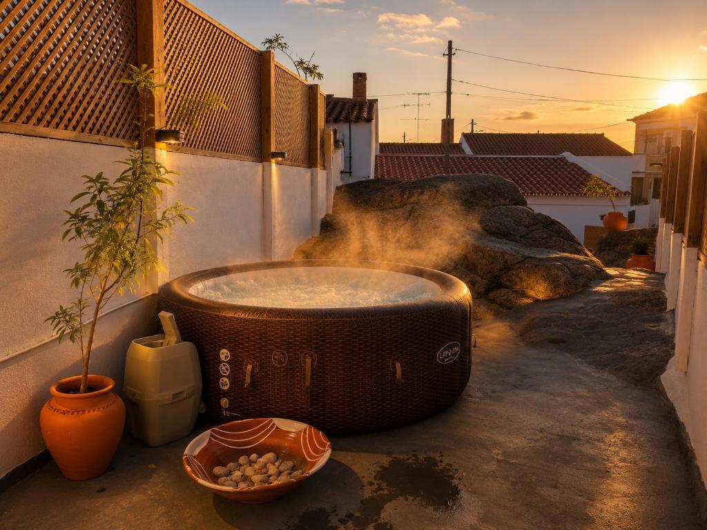 a bath tub sitting on the side of a building at Descanso dos oleiros in Aldeia do Mato