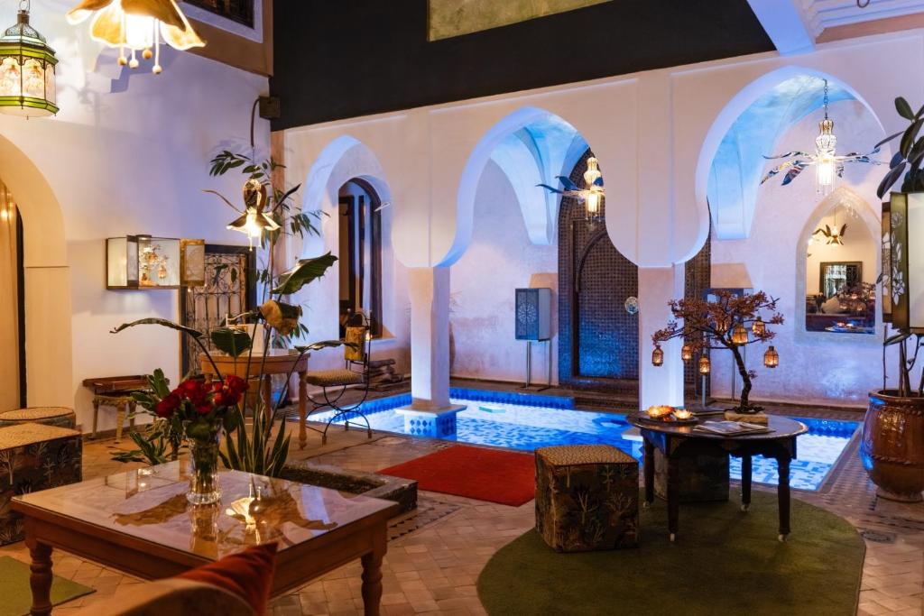 a living room with a pool in the middle at Riad Al Ibtikar in Marrakesh