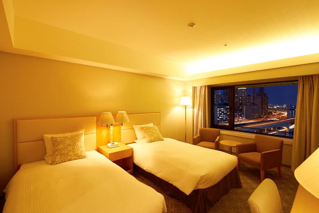 Postel nebo postele na pokoji v ubytování Hotel Okura Kobe