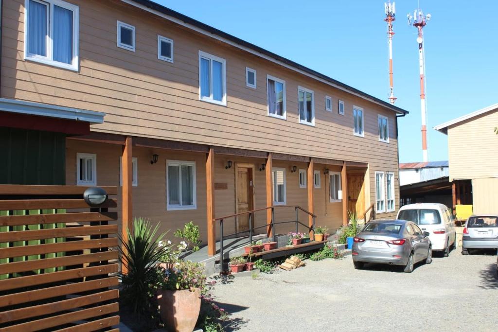 a house with cars parked in front of it at Hostal Internacional Valdivia in Valdivia