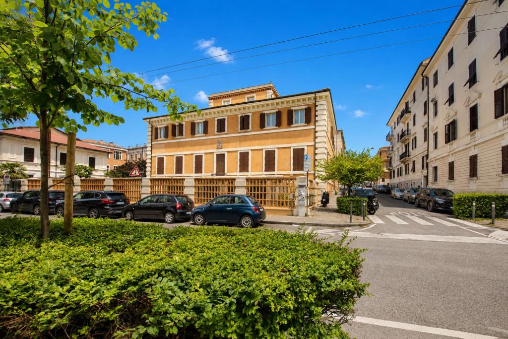 a building with cars parked in front of a street at Hotel della Vittoria in Ancona