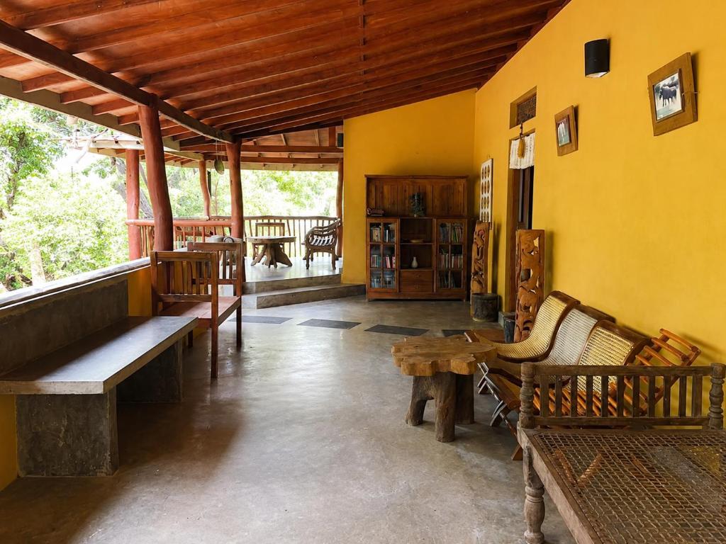 a room with benches and a table in a building at Eth Mansala in Sigiriya