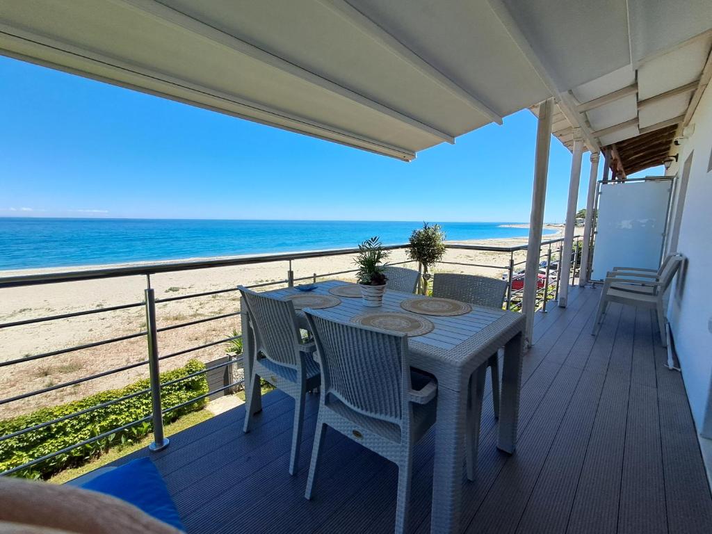 a table and chairs on a balcony with the beach at Aegean Infinite View-Beachfront Suite Pelion in Chorefto