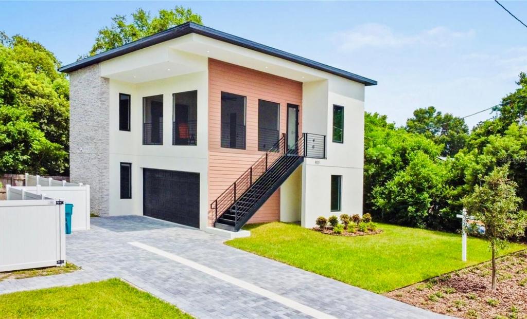 a house with a staircase in front of it at The Sunshine Studio - No Smoking in Orlando
