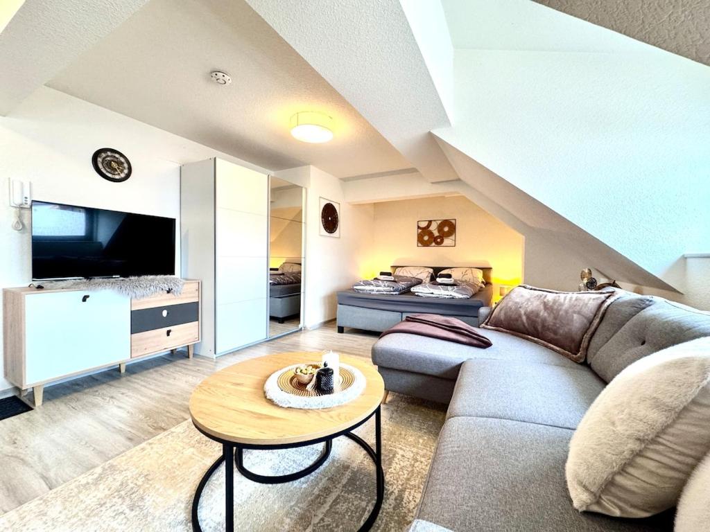 a living room with a couch and a table at Ferienwohnung Artemis in Eggingen