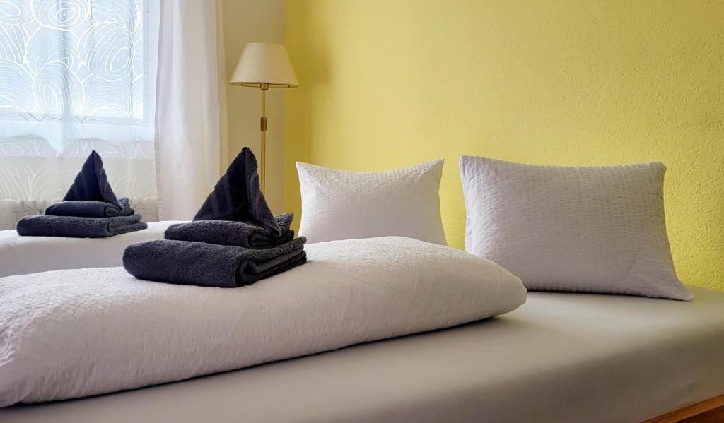 two pillows sitting on top of a bed at Hotel Bellavista Ftan in Ftan