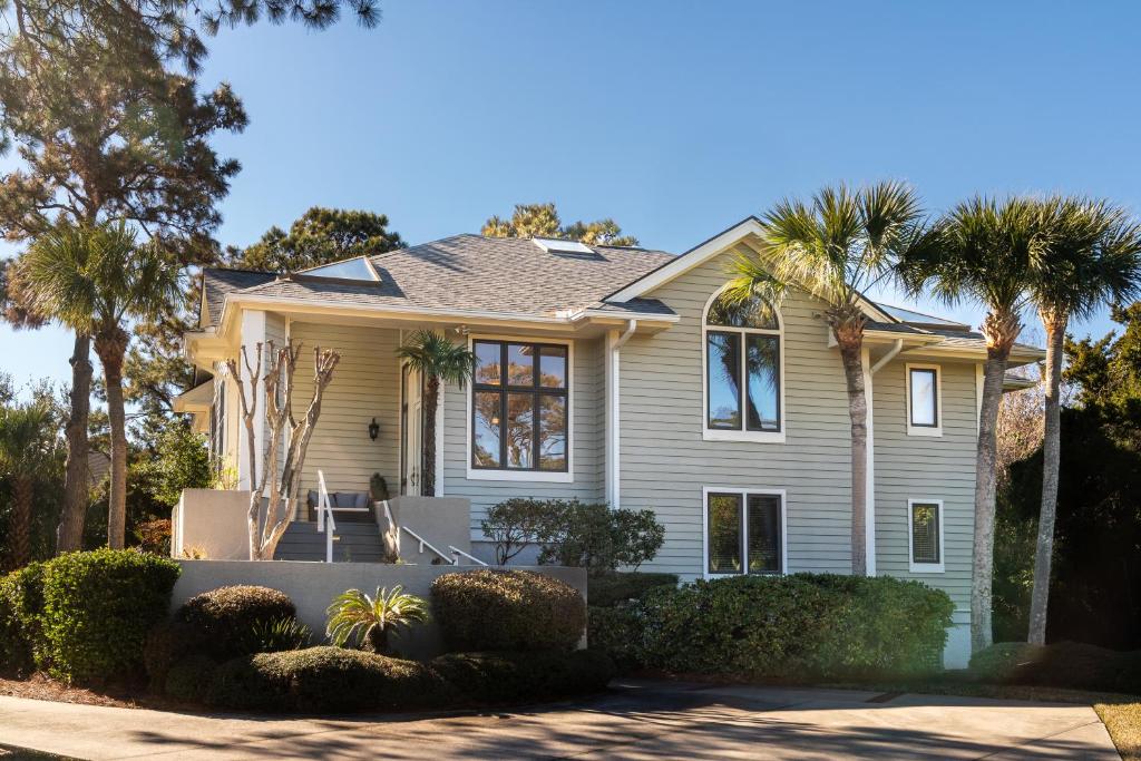 a house with palm trees in front of it at 2251 Catesby's Bluff in Seabrook Island