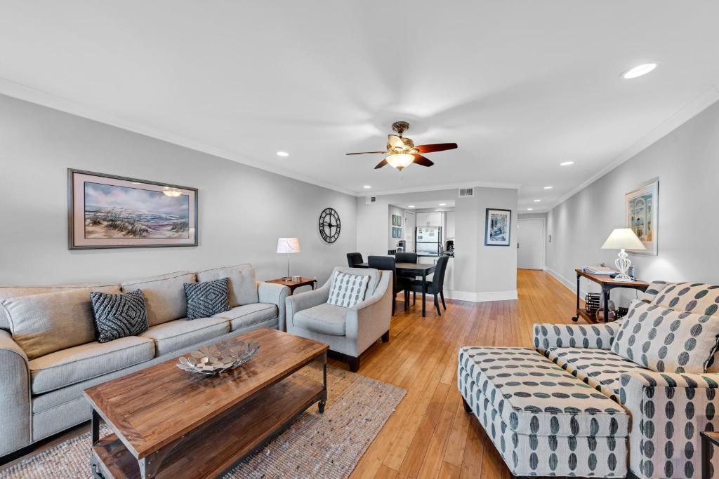 a living room with a couch and a table at 1303 Pelican Watch Villa in Seabrook Island