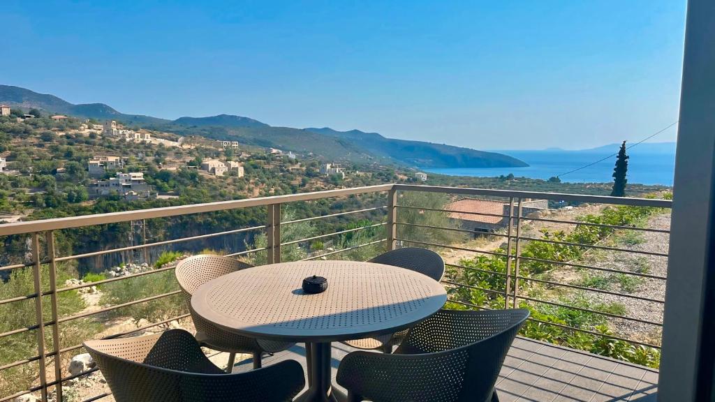 a table and chairs on a balcony with a view at Nodeas Villa in Kalamata