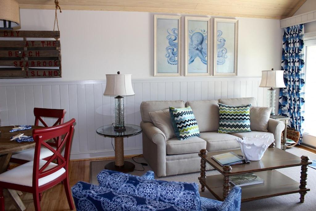 a living room with a couch and a table at 13106 Pelican Watch Villa in Seabrook Island