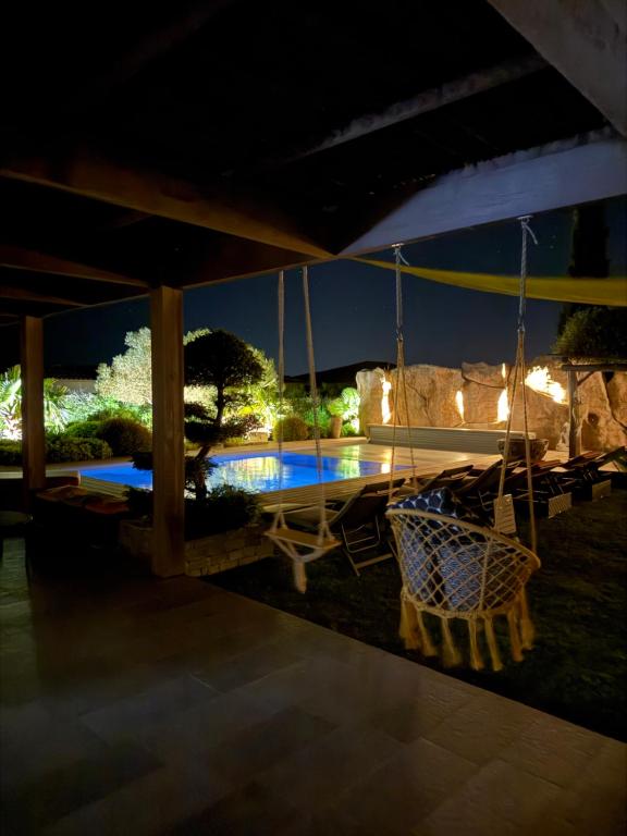 an outdoor patio with a table and chairs at night at Casa Avvena 1 in Lecci