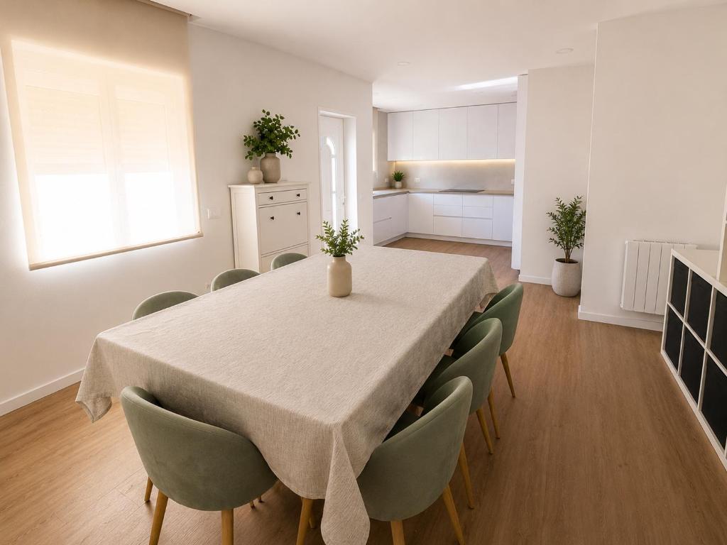 a kitchen and dining room with a table and chairs at Waves beach house in Viana do Castelo