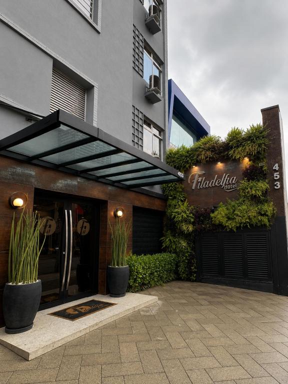 a building with awning on the side of it with plants at Filadelfia Hotel in São Paulo