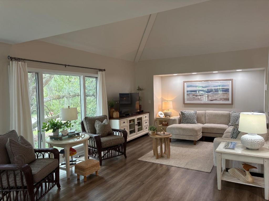 a large living room with a couch and chairs at 767 Spinnaker Beach House in Seabrook Island