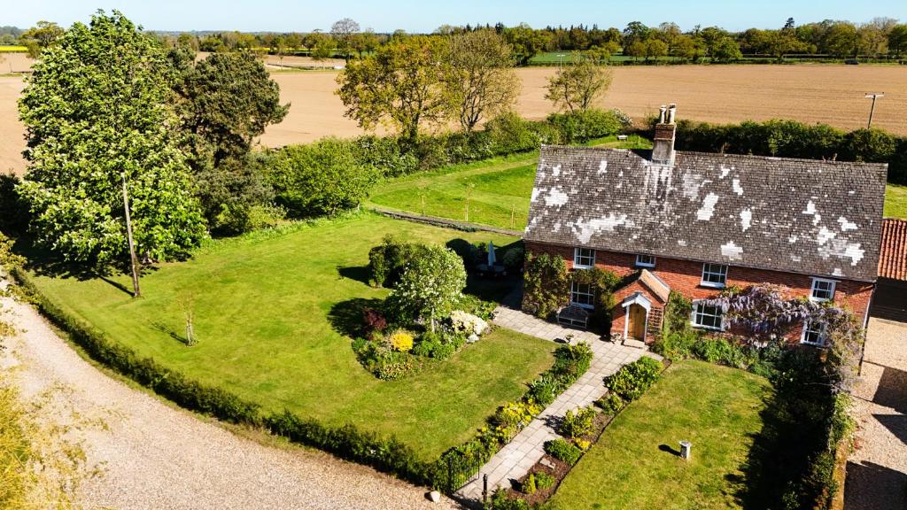 an aerial view of a house with a garden at Cutbush Farmhouse in Norwich