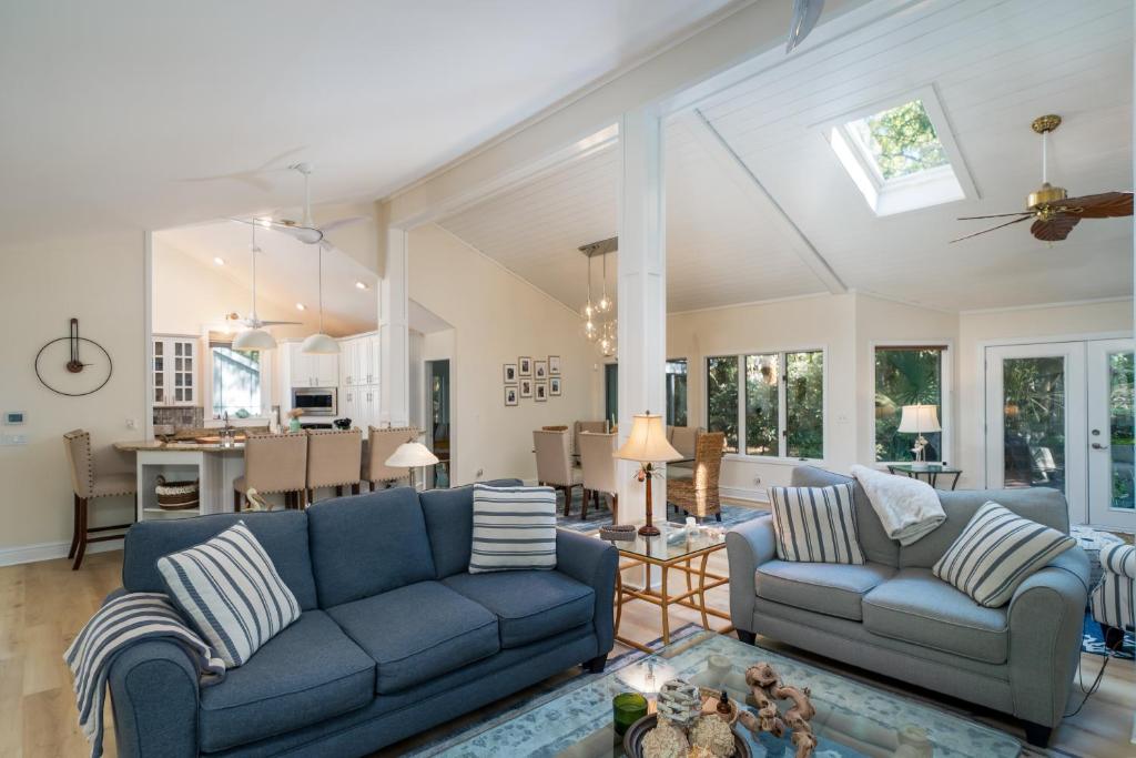 a living room with two blue couches and a kitchen at 2932 Captain Sams in Johns Island