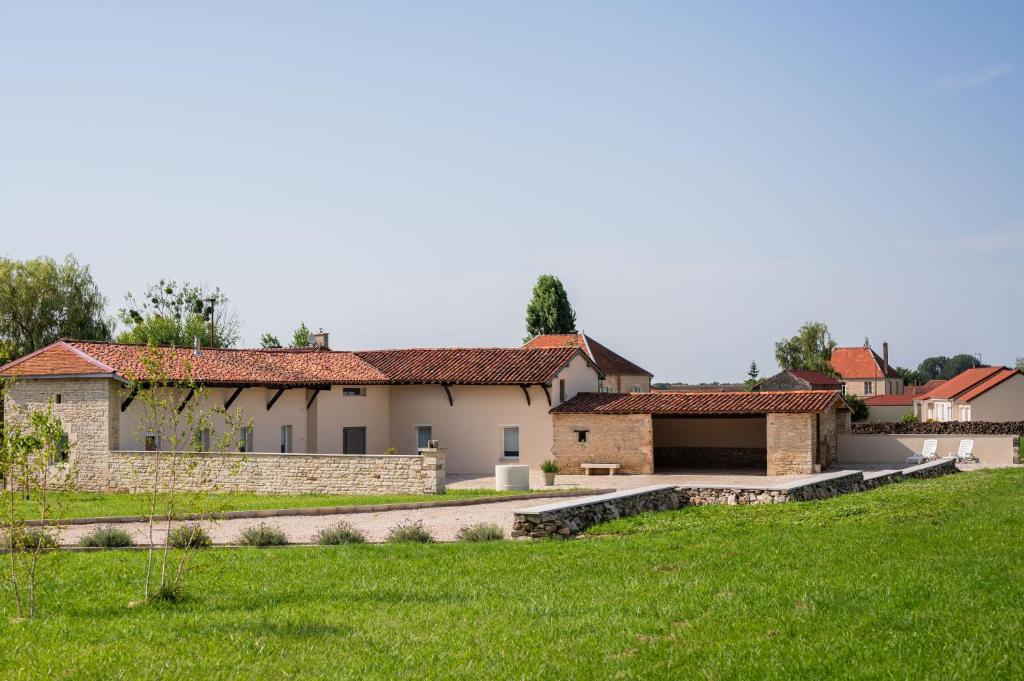 a house with a green lawn in front of it at Old Farmhouse in Chaumesnil