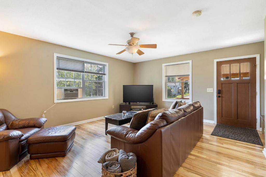 a living room with leather furniture and a flat screen tv at Cozy Corner in Oswego