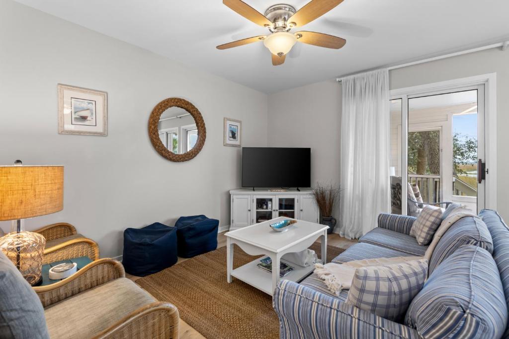 a living room with a couch and a tv at 1807 Heron Pt in Seabrook Island