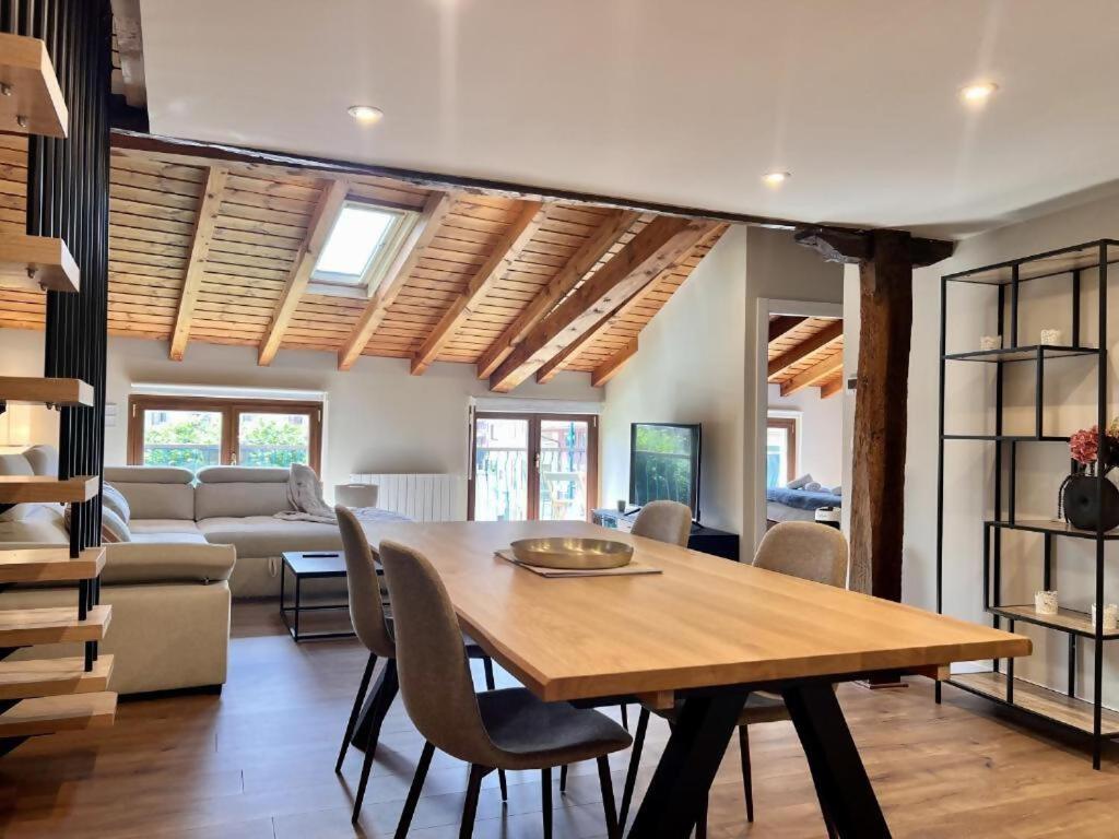 a dining room with a table and a couch at Kantauri Homes- KAI in Bermeo