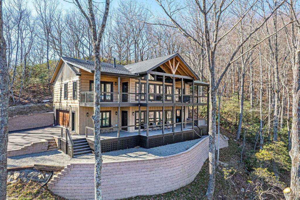 a large wooden house in the middle of the woods at Luxury Log Cabin with lake view in Black Mountain