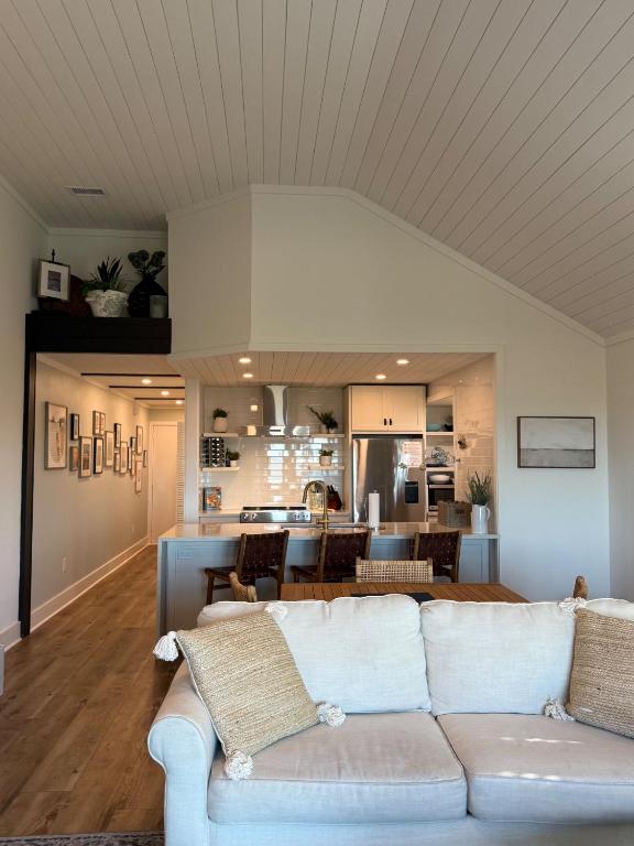 a living room with a couch and a kitchen at 1338 Pelican Watch Villa in Seabrook Island