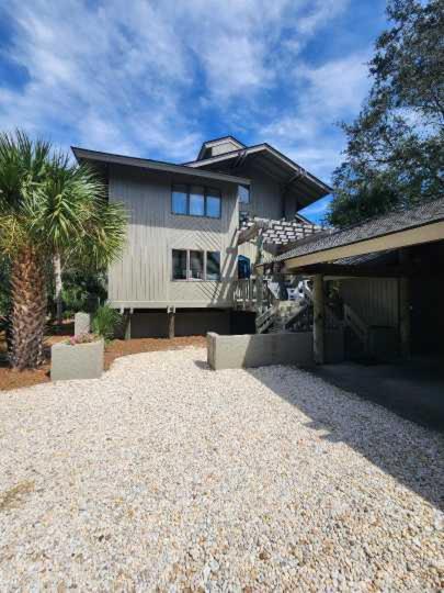 a large house with a palm tree in front of it at 2264 Seascape Crt. in Seabrook Island
