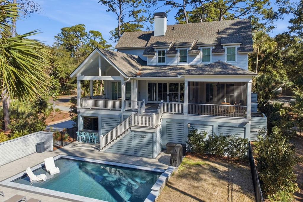 a house with a swimming pool in front of it at 3290 Coon Hollow in Seabrook Island
