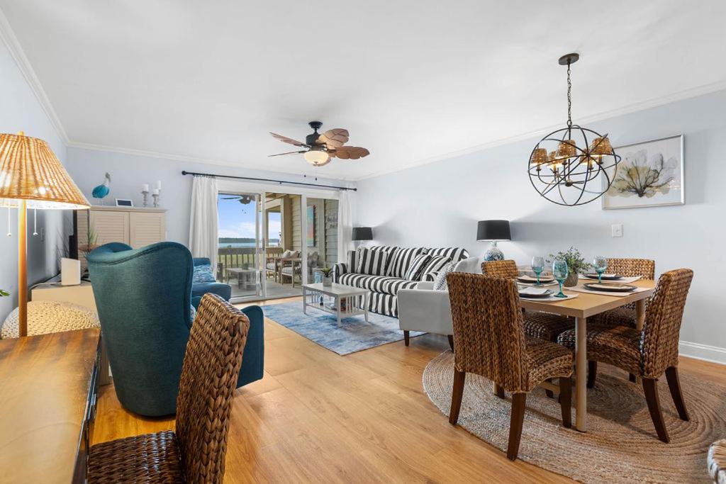 a living room with a table and chairs at 1327 Pelican Watch Villa in Seabrook Island