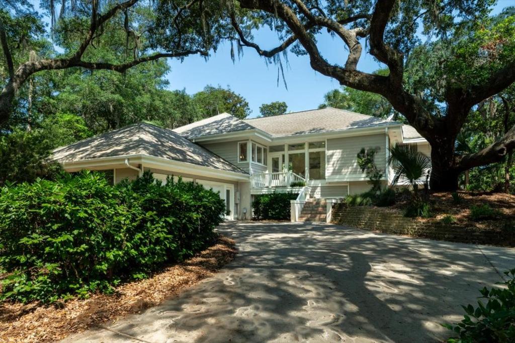 a white house with a tree and a driveway at 2710 Gnarled Pine in Seabrook Island
