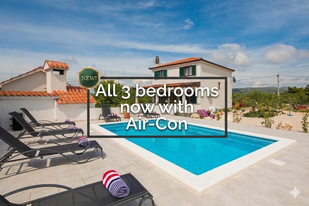 a villa with a swimming pool and a house at Villa Sunshine in Rogoznica