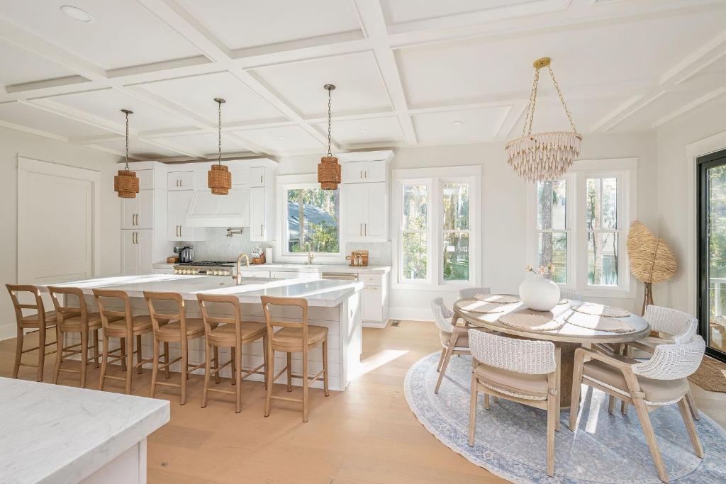 a white kitchen with a table and chairs at 3151 Baywood Drive in Seabrook Island