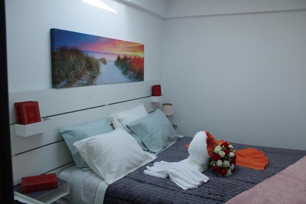 a bedroom with a bed with a towel on it at Alojamento ceu azul in Fernao Ferro
