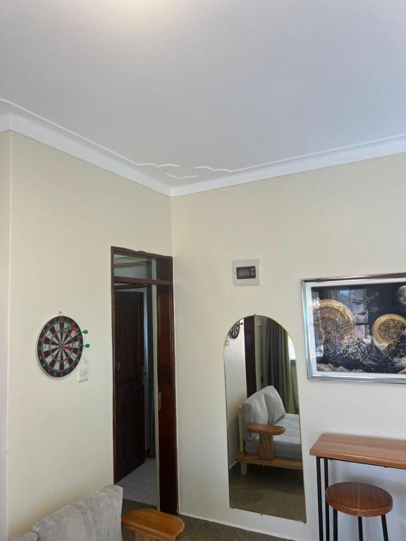 a living room with a couch and a mirror at Robchen homes in Entebbe