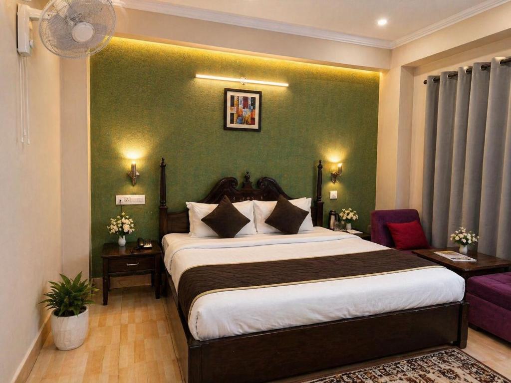 a bedroom with a large bed and a green wall at Aachman Regency Shimla Mallroad in Jutogh