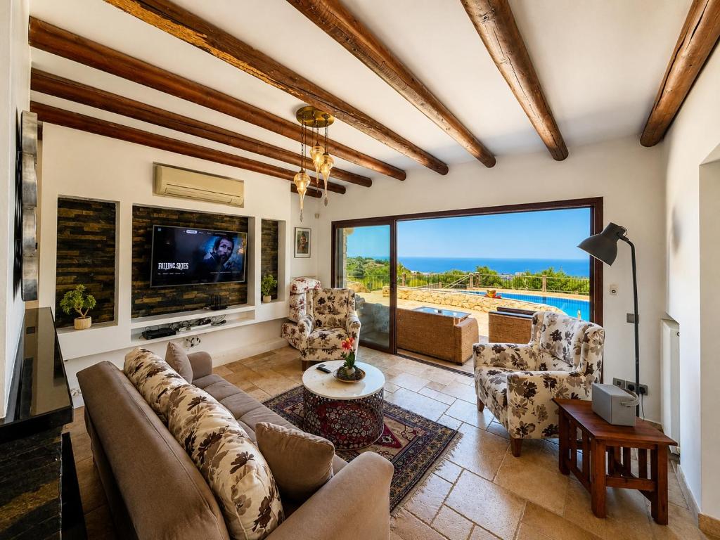 a living room with a couch and a tv at Bellapais Stone Villa in Kyrenia