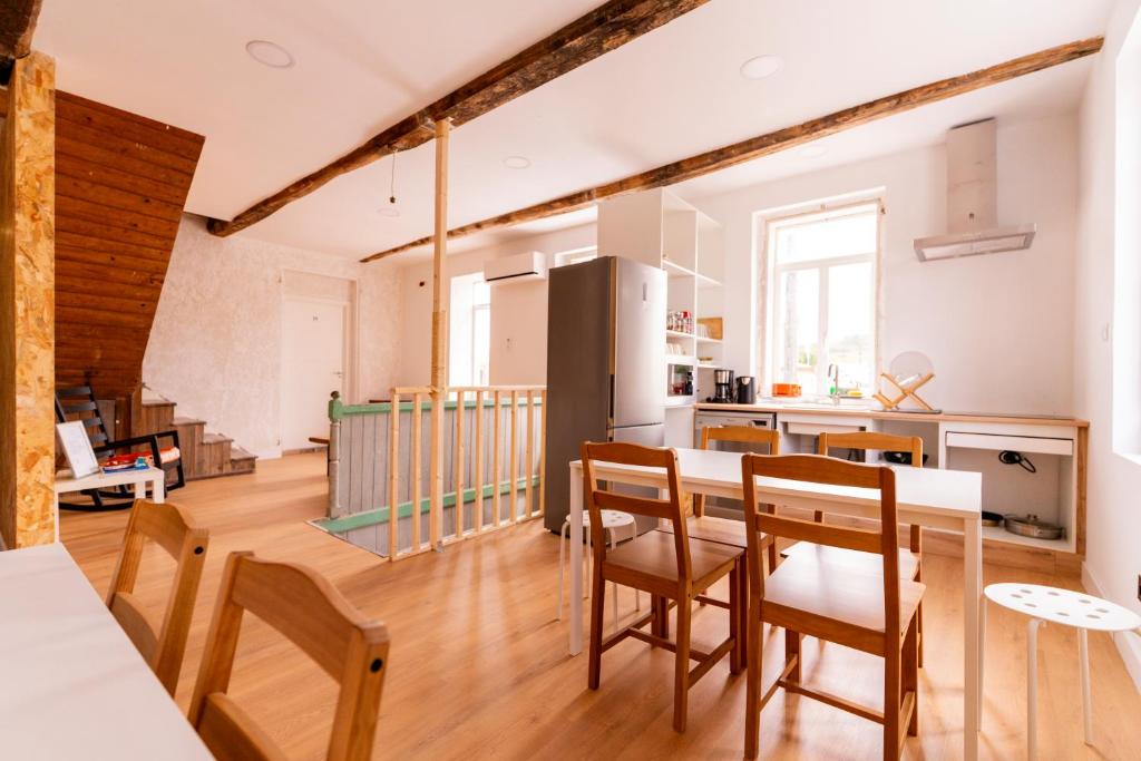 a kitchen and dining room with a table and chairs at Casa Bubela- Vía de la plata in Dozón