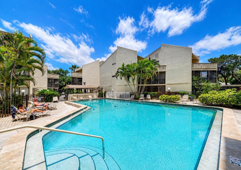 a swimming pool in front of a building at Siesta Key Beach - 2 Bedroom - 3 Beds - 3 Bathroom Duplex with Heated Swimming Pool in Siesta Key