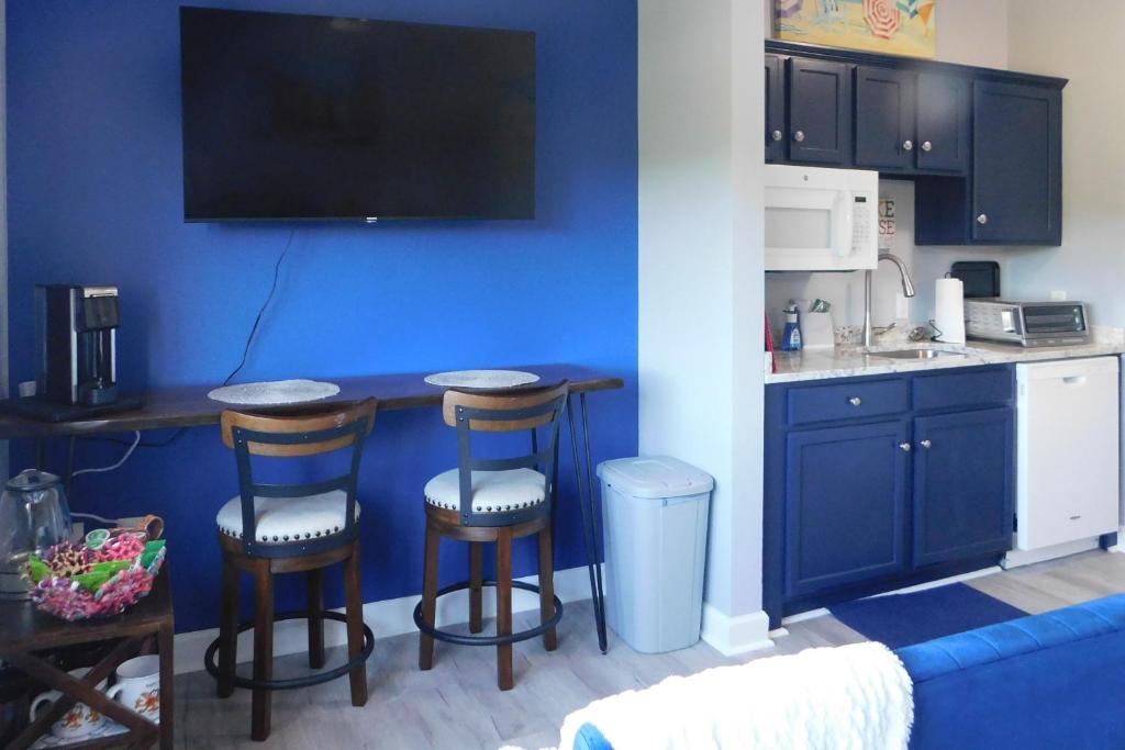 a kitchen with a counter and two bar stools at Surfboard-Themed Huddleston Studio w/ Beach Access in Huddleston