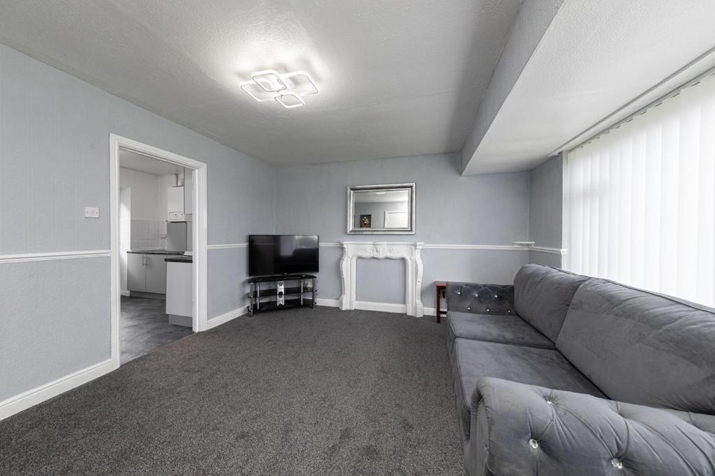a living room with a couch and a television at Henley Haven in Pelton Fell