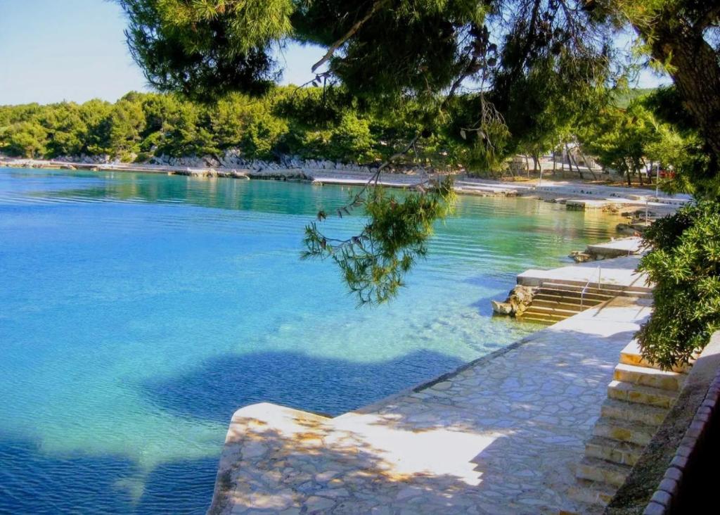 a view of a body of water with trees at Laura Apartment in Tribunj