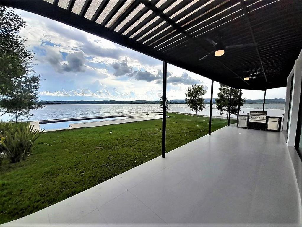 a porch of a house with a view of the water at Casa en Lago Rapel, Quebrada Honda in Lago Rapel