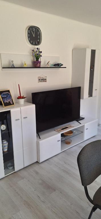 a living room with a large white entertainment center with a tv at Elizabeth in Komárom