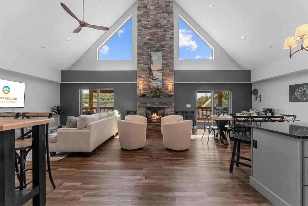 a living room with a vaulted ceiling and a fireplace at Green Wood Getaway - for 18 in Hollister