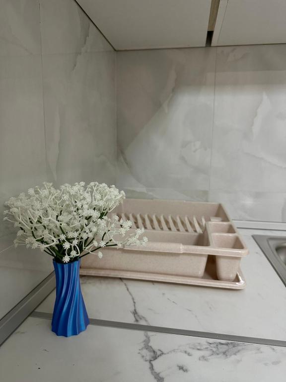a blue vase with white flowers sitting on a table at Laki in Donji Štoj